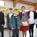 Priti Patel presents pupils from Woodham Walter Primary School with a basket containing assorted seeds, gardening tools and a book on plants and insects.